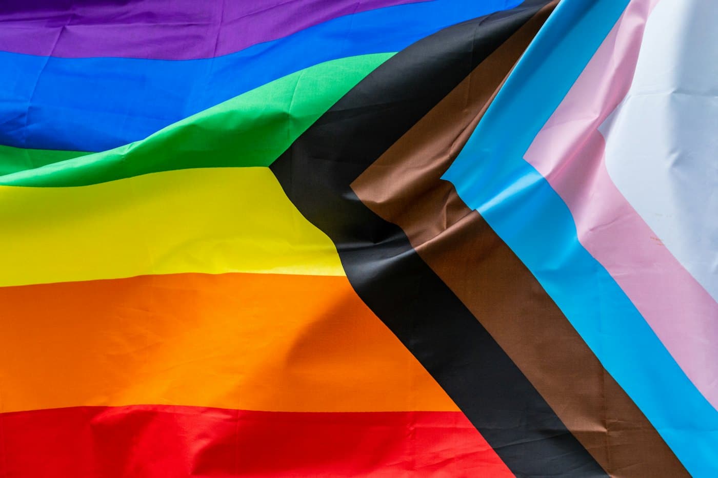 Close-up of the stripes and chevron of a Progress Pride flag