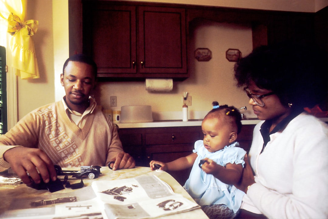 Photograph showing FamilySittingatKitchenTableAnAfricanAmeric — illustrating healthcare programmes in Africa